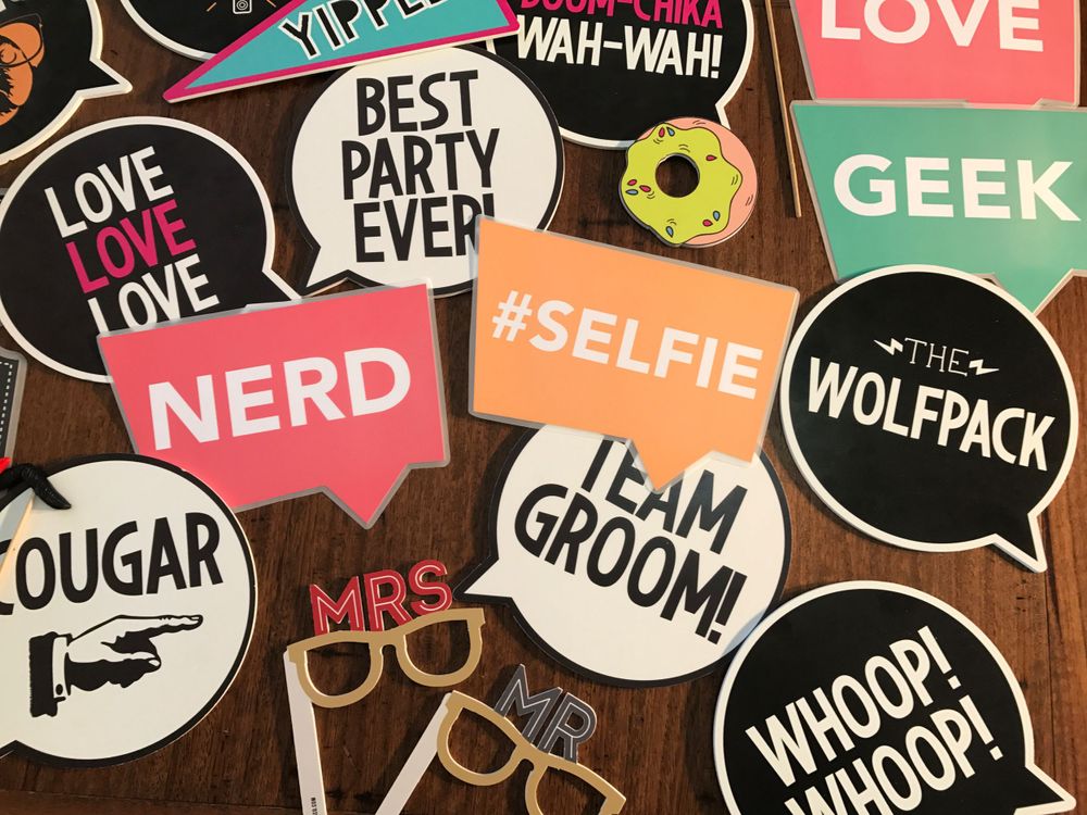 Guests using photo booth props at a Snap Click Booth event
